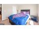 Bedroom features neutral walls, carpet, and a dark wood bed frame with bright bedding at 7019 Diamond Dr, Rex, GA 30273
