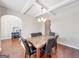 Dining room with coffered ceilings, modern chandelier, and stylish decor at 7019 Diamond Dr, Rex, GA 30273