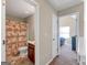 Hallway shows the bathroom and a bedroom with natural light coming from a window at 7019 Diamond Dr, Rex, GA 30273