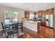Eat-in kitchen featuring stainless steel appliances, granite countertops, breakfast bar, and dining table at 7019 Diamond Dr, Rex, GA 30273