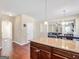 Spacious kitchen featuring granite countertops, hardwood floors, and a view into the adjacent living areas at 7019 Diamond Dr, Rex, GA 30273