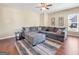 Cozy living room with hardwood floors, a ceiling fan, a neutral color scheme, and a large sectional sofa at 7019 Diamond Dr, Rex, GA 30273