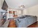 Open living room with a stone fireplace and a view into the kitchen area, featuring hardwood floors at 7019 Diamond Dr, Rex, GA 30273