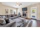 Comfortable living room featuring a stone fireplace, a ceiling fan, and a large sectional sofa at 7019 Diamond Dr, Rex, GA 30273
