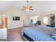 A large carpeted primary bedroom shows stylish furniture with matching finishes and vaulted ceiling at 7019 Diamond Dr, Rex, GA 30273