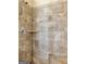 Tiled walk-in shower featuring a built-in shelf and a hand-held shower head at 7019 Diamond Dr, Rex, GA 30273