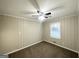 Comfortable bedroom featuring a ceiling fan, carpeted floors, and a large window at 20 Maddox Dr, Locust Grove, GA 30248