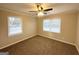 Comfortable bedroom featuring neutral walls, a ceiling fan, and two windows for ample natural light at 20 Maddox Dr, Locust Grove, GA 30248