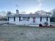 Cozy single-story home featuring a brick exterior, black shutters, and front porch entry at 20 Maddox Dr, Locust Grove, GA 30248