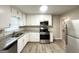 Modern kitchen featuring stainless steel appliances, granite countertops, and white cabinetry at 20 Maddox Dr, Locust Grove, GA 30248