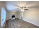 Bright living room featuring a decorative fireplace, hardwood floors, and a ceiling fan at 20 Maddox Dr, Locust Grove, GA 30248