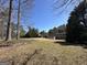 Expansive backyard with well-maintained lawn and view of a two-story home with a large deck at 345 Gaelic Way, Tyrone, GA 30290