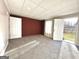 Finished basement space with access to the backyard and a red accent wall at 345 Gaelic Way, Tyrone, GA 30290