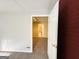 Basement featuring red accent wall and view of another bathroom in the background at 345 Gaelic Way, Tyrone, GA 30290