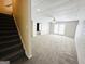 Finished basement space with stairs, neutral carpet, and walkout access at 345 Gaelic Way, Tyrone, GA 30290