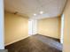 Finished basement with carpet, neutral walls, drop ceiling and several doorways at 345 Gaelic Way, Tyrone, GA 30290