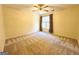 Spacious bedroom with neutral carpet, a ceiling fan with lights, and a bright window at 345 Gaelic Way, Tyrone, GA 30290