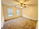 Bright bedroom featuring neutral walls, carpet flooring, a ceiling fan, and a window with blinds at 345 Gaelic Way, Tyrone, GA 30290