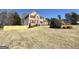 Two-story brick home featuring shuttered windows, dormers, landscaped yard and wooden fence at 345 Gaelic Way, Tyrone, GA 30290