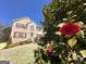 Two-story brick home featuring shuttered windows and landscaped yard with a flowering bush at 345 Gaelic Way, Tyrone, GA 30290