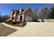 View of the brick home with an attached garage, complemented by a concrete driveway and yard at 345 Gaelic Way, Tyrone, GA 30290