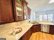 View of a kitchen with wood cabinets, stainless steel sink, stone backsplash, and stainless steel appliances at 345 Gaelic Way, Tyrone, GA 30290