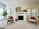 Bright living room showcasing a fireplace and large windows at 345 Gaelic Way, Tyrone, GA 30290