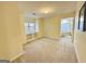 Neutral colored primary bedroom featuring built-in shelves, and doorway to a spacious bathroom at 345 Gaelic Way, Tyrone, GA 30290