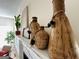 Eye-level view of fireplace mantel, decorated with vases and plants, adding a touch of nature and elegance to the living space at 345 Gaelic Way, Tyrone, GA 30290
