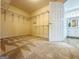 Spacious walk-in closet with carpet and wire shelving, connecting to a bathroom at 345 Gaelic Way, Tyrone, GA 30290