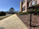 Street view showing a sidewalk lined with mulch and leading to a two-story brick home at 345 Gaelic Way, Tyrone, GA 30290
