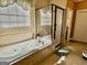 Bathroom featuring a large bathtub, tile floors, and a glass shower at 108 Caraway Rd, Locust Grove, GA 30248