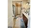 Bathroom featuring a glass shower, double vanity, tile floors, and natural light at 108 Caraway Rd, Locust Grove, GA 30248