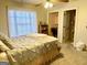 Carpeted bedroom features a ceiling fan and en-suite bathroom at 108 Caraway Rd, Locust Grove, GA 30248