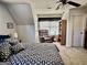 Comfortable bedroom with a ceiling fan, an upholstered chair and a window at 108 Caraway Rd, Locust Grove, GA 30248
