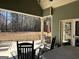 Relaxing covered patio featuring comfortable seating and a serene outdoor ambiance at 108 Caraway Rd, Locust Grove, GA 30248