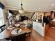 Open-concept dining area featuring a chandelier, dark wood floors, and seamless access to the kitchen and living spaces at 108 Caraway Rd, Locust Grove, GA 30248