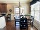 Breakfast area with wooden table, six chairs, hardwood floors, and plenty of natural light at 108 Caraway Rd, Locust Grove, GA 30248