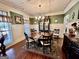 Charming dining room with a decorative chandelier, wainscoting, and large windows at 108 Caraway Rd, Locust Grove, GA 30248