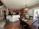 Open-concept kitchen featuring a spacious island, stainless steel appliances, and a dining area with hardwood floors at 108 Caraway Rd, Locust Grove, GA 30248