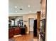 Modern kitchen featuring dark wood cabinetry, granite countertops, and stainless steel appliances with ample counter space at 108 Caraway Rd, Locust Grove, GA 30248
