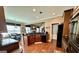 Open kitchen with a view of the dining room and living area, featuring dark cabinets and stainless steel appliances at 108 Caraway Rd, Locust Grove, GA 30248