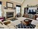 Inviting living room with a stone fireplace, custom built-ins, and plush carpeting at 108 Caraway Rd, Locust Grove, GA 30248