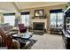 Cozy living room boasting a fireplace, large windows, and comfortable seating at 108 Caraway Rd, Locust Grove, GA 30248