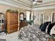 Spacious main bedroom featuring a four-poster bed and a tray ceiling at 108 Caraway Rd, Locust Grove, GA 30248