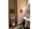 Cozy powder room with pedestal sink and decorative accents at 108 Caraway Rd, Locust Grove, GA 30248