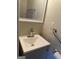 Practical bathroom featuring a modern vanity, mirror, and accessible features at 718 N Hairston Rd, Stone Mountain, GA 30083