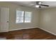 This bright bedroom features hardwood floors, a window and neutral paint at 718 N Hairston Rd, Stone Mountain, GA 30083