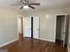 Spacious bedroom featuring hardwood floors, a ceiling fan, closet and neutral paint at 718 N Hairston Rd, Stone Mountain, GA 30083
