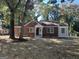 Charming brick home showcasing an inviting front entrance and manicured lawn on a sunny day at 718 N Hairston Rd, Stone Mountain, GA 30083